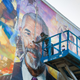 Ernel Martinez installing the Ed Bradley mural.